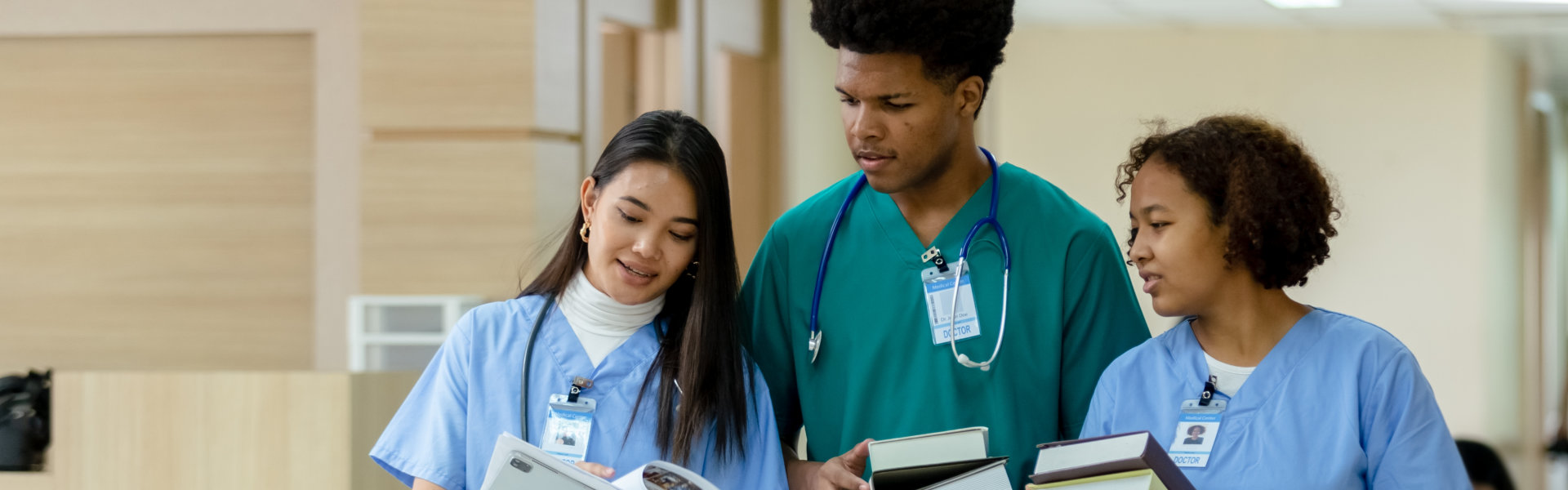 group of medical student holding book walking and talking in university